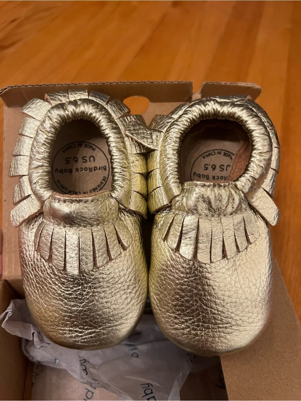 BirdRock Baby genuine leather moccasins feature a shiny gold shoes